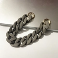 Detail of grey frosted resin thick chain strap with golden round spring buckles - 30cm / Gray