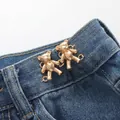 Golden mini bear waist buckle pins for jeans adjustment on blue denim fabric - Hand-sewn Bear / Flowing Gold