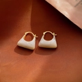 Macro detail of cream pearlescent handbag-shaped earrings with gold geometric hardware - 28# Ear Buckle-Off-White Handbag Shaped Enamel Earrings