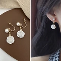 Detail of white rose and pearl earrings with golden clip-on design shown on a model - Rose Pearl Pendant Clip-on