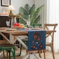Blue table runner with floral embroidery and tassel accents in a cozy dining setting - Blue Bottle + Red Tassel (Hand Wash Only)