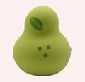 Macro view of green pear-shaped makeup sponge with leaf pattern on pink background - Printed Green Pear