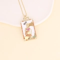 Detail of 18K gold tarot pendant necklace with multicolored zircons and LA FORZA engraving - 5# Orange (Strength)