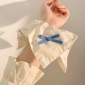 Cream vintage floral scrunchie with blue bow accent shown on model's wrist - White Bowknot Scarf Style