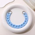 Close-up of a light blue acrylic chain strap with silver metal ring clasps on ceramic - Blue