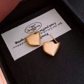 Détail macro de boucles d'oreilles géométriques dorées mates sur fond blanc - Géométrie en Or Mat Irrégulier (26#)