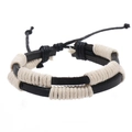 Detail of handmade black leather bracelet featuring cream cotton cord weave and knot - Black Leather White Wire