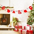 Christmas felt ornaments featuring gloves, hats, socks and snowflakes on red rope banner - Glove and Stocking Banner