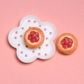 Macro detail of miniature strawberry tart charms on a pink polka dot plate accessory - Strawberry Egg Tart
