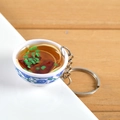 Miniature blue and white porcelain bowl keychain with realistic noodle soup and metal ring - Pork Chop Noodles