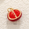 Macro shot of a 13mm red pomegranate pendant with gold trim for jewelry making - Pomegranate