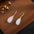 Detail of elegant gold drop earrings with white chalcedony stones and small diamonds - E2755-12/Gold Hook White Drop