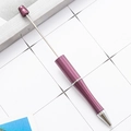 Purple metallic DIY beadable ballpoint pen with sleek silver tip on a modern desktop - Deep purple