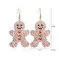 Detailed view of gingerbread man earrings with gold glitter and holiday heart accents - Heart Gingerbread Man Earrings