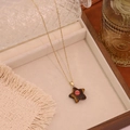 Detailed shot of star stone pendant necklace with pink bead on a soft jewelry display - 7# Tiger Eye