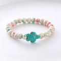 Detailed close-up of a white marbled bead bracelet featuring a turquoise turtle charm - Pink Green Splatter Turquoise Turtle Bracelet