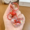 Cute red heart keychain with liquid quicksand, colorful stars and a small metal bell - Red Heart Sparkle