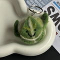 Handmade wool felt keychain featuring a cute green cabbage with a smiling face detail - Cabbage