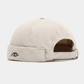 Close-up of beige Miki hat featuring black eye embroidery and thick cotton canvas texture - Adjustable / Beige