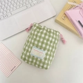 Detail of green and white checkered quilted camera storage bag with pink drawstring closure - Plaid Green