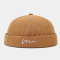 Detailed close-up of khaki docker hat with white 'me' embroidery on the rolled brim edge - Adjustable / Caramel color