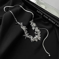 Macro detail of polished silver leaf pendants on a sleek snake chain necklace - Silver