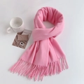 Flat lay detail of pink cashmere-like scarf with twisted tassels and decorative mug - Regular Fit / Hot Pink