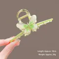 Detail of a large 10cm gold metal butterfly hair claw with green enamel wings - K114 Green Butterfly