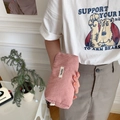 Pink corduroy pencil case with a zipper closure and brand label shown in hand - Nude Pink