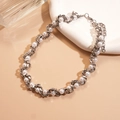 Elegant silver metallic S-link chain entwined with white pearls on a minimalist warm background - Silver