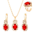 Detailed close-up of golden bridal jewelry set with large red oval gemstones and crystals - Oval KC Gold Bright Red Style (11730)