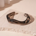 Minimalist dark gray acrylic bangle with irregular wave design and smoke pattern texture - Black