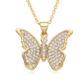 Close-up of gold-plated butterfly pendant with sparkling cubic zirconia on a fine chain - F239