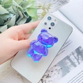 Detail of a purple and blue gradient 3D bear Griptok phone stand on a white smartphone - Metallic Purple