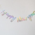 Close-up of holographic Happy New Year banner with colorful laser finish for party decor - Connected Rainbow Multicolor