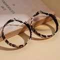 Macro shot of leopard print hoop earrings resting on vintage book with warm soft lighting - Hoop Earrings - Coffee Brown - Round (5cm)