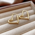 Detailed view of polished irregular heart-shaped gold earrings in a wooden jewelry box - 12# Ear Buckle - Golden Heart / Gold