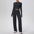 Detail view of black fitness set with zip-up top thumb holes and high waist wide leg pants - S / Black