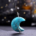 Macro view of turquoise crescent moon pendant with silver tree of life wire wrapping - Turquoise