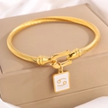 Golden twisted cable bracelet with Cancer zodiac pendant and white enamel inlay - Gold Cancer