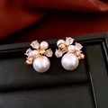 Detailed close-up of 18K gold plated pearl stud earrings with sparkling cubic zirconia - Gold Cluster Pearl Zircon Earrings