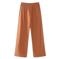 Detailed view of caramel brown wide-leg trousers with elastic waist on white background - Orange Pants