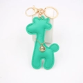 Detail of green PU leather giraffe keychain with gold ring and sparkling rhinestone charm - Green