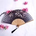Bamboo folding fan featuring a dark gradient canopy with pink cherry blossoms and black tassel - Dark Gradient Cherry Blossom Style (Smiling Woman's Fan-76)