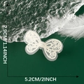 Macro shot of white lace bow patch showing 2.9cm x 5.2cm dimensions on green background - White Mesh Bow Style (12)