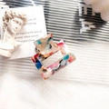 Rectangular acetate hair claw clip with colorful marble pattern and cutout design - Rainbow