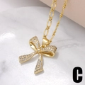 Collana con ciondolo a fiocco dorato con pavé di zirconi e catena Figaro - Catena Figaro Fiocco (C)