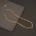 Detail of gold curb chain link necklace with lobster clasp and extension chain on slate - Gold Interlocking Ring Link Chain (9#)
