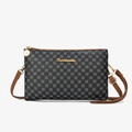 Dark grey monogram crossbody bag with floral pattern, brown strap, and gold hardware - Gray