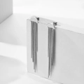 Minimalist silver stainless steel long tassel earrings on a geometric stone display - Silver